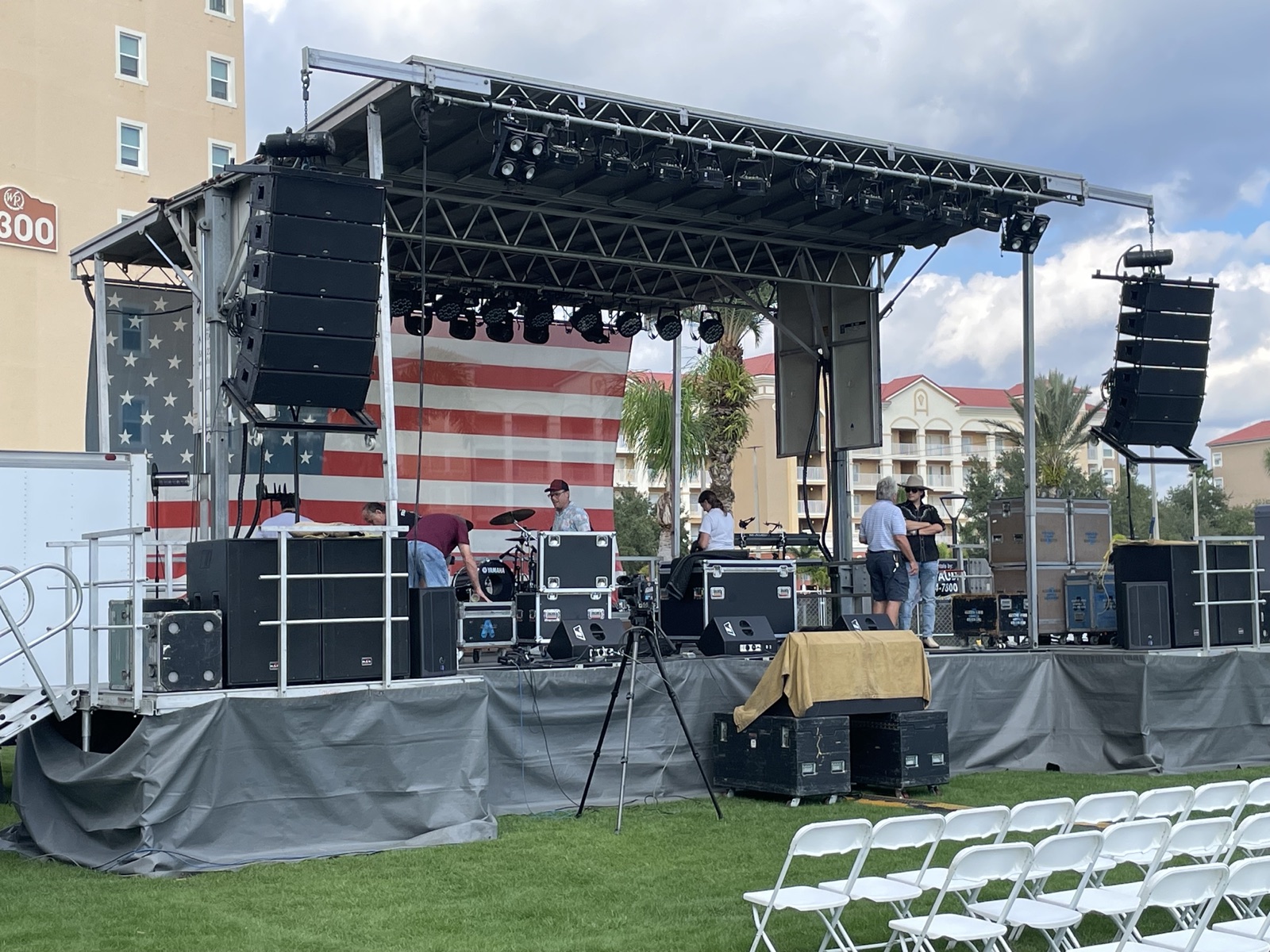 Outdoor stage build with truss lighting and line-array speakers